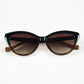 Folded view of Aarka Rosea designer cat-eye sunglasses with brown and black frame and polarized lenses.