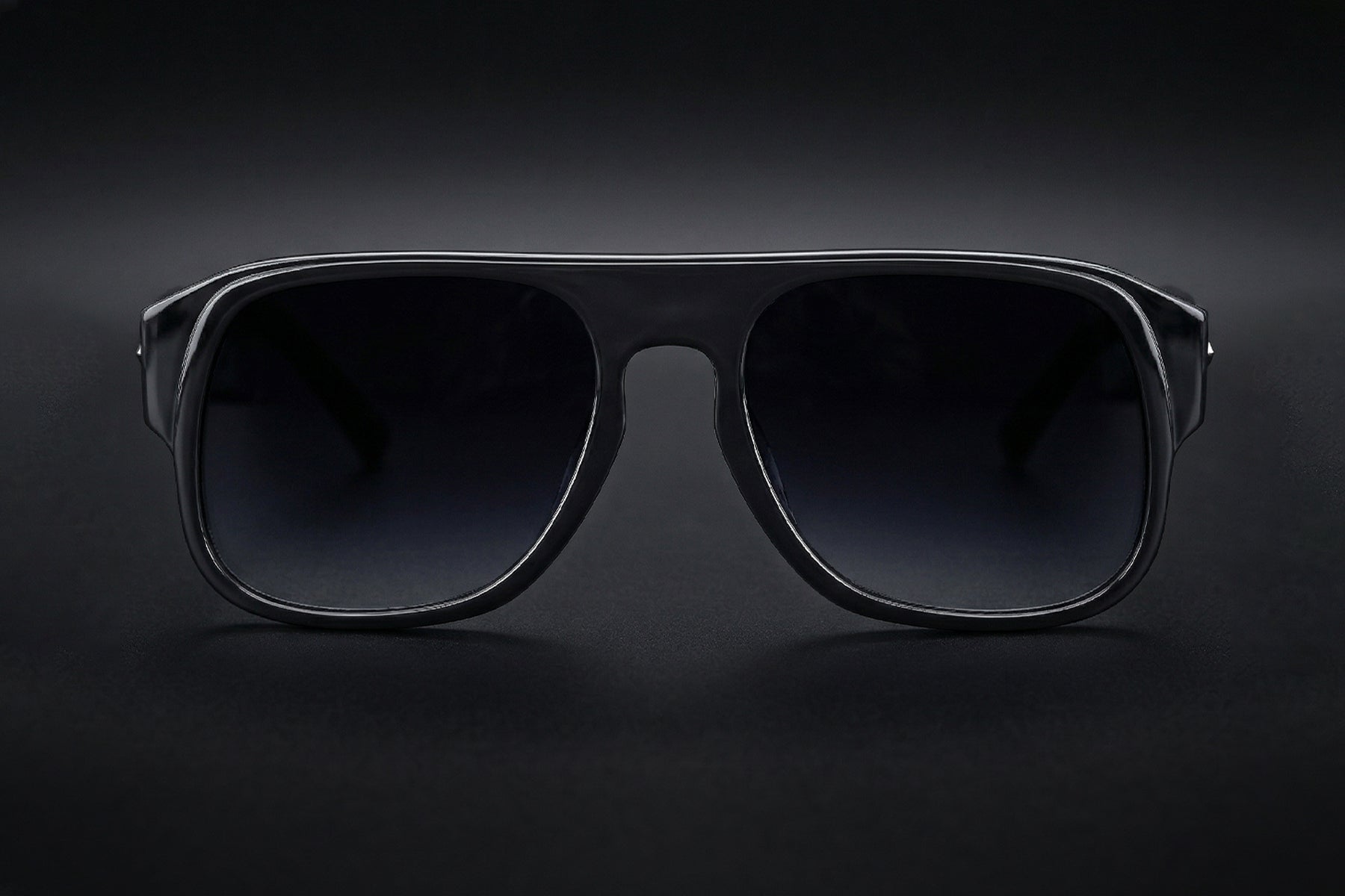 AARKA Aster C1 polarized aviator sunglasses featuring a black and grey gradient full-rim frame with tinted lenses, shown in a front view.