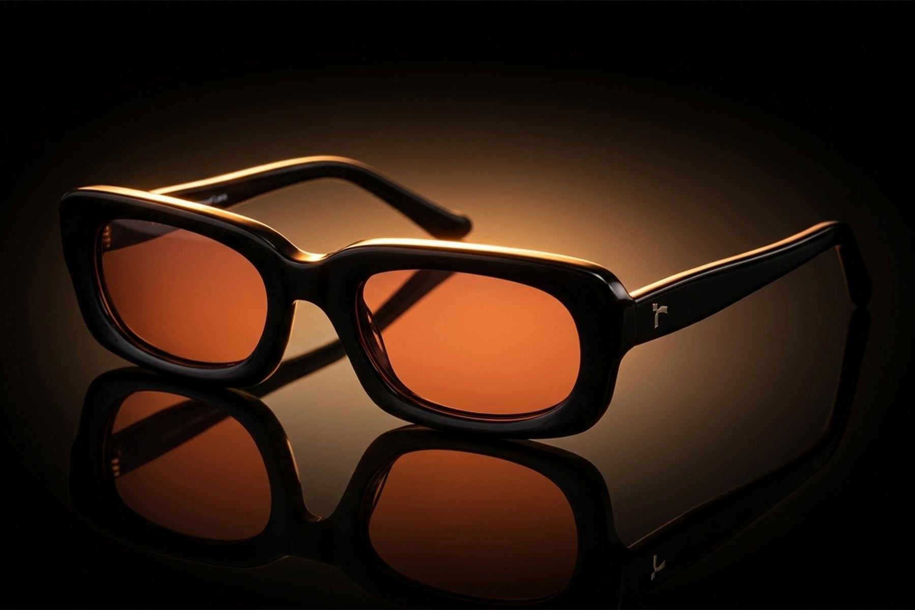 AARKA Elbrus C2 polarized irregular rectangle sunglasses featuring a black and orange full-rim frame with tinted lenses, displayed in a premium studio setting.
